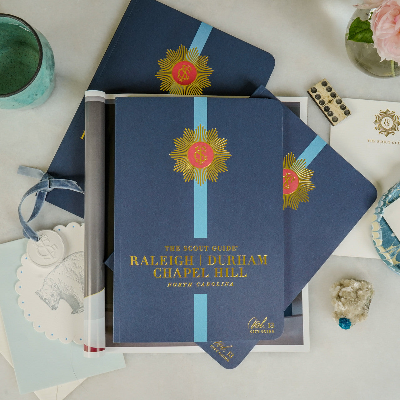 The Scout Guide Raleigh, Durham, & Chapel Hill Volume 13, dark blue cover with turquoise stripe, gold foil title and TSG Medallion logo