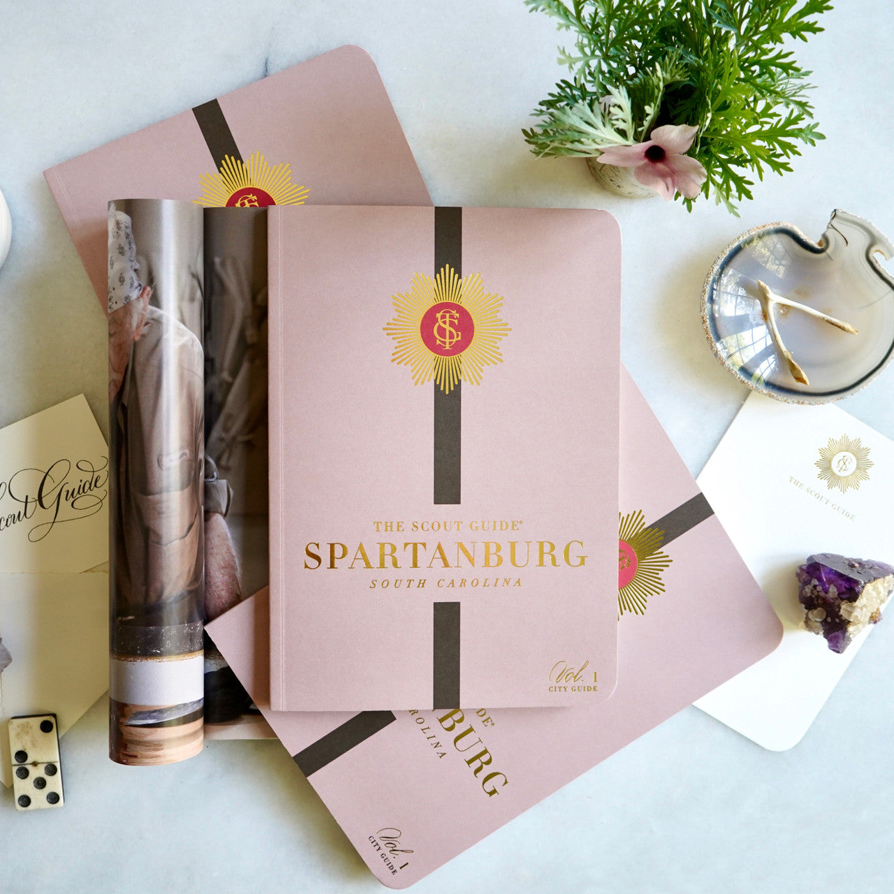 The Scout Guide Spartanburg Volume 1, light brown cover with dark brown stripe, gold foil title and TSG Medallion logo