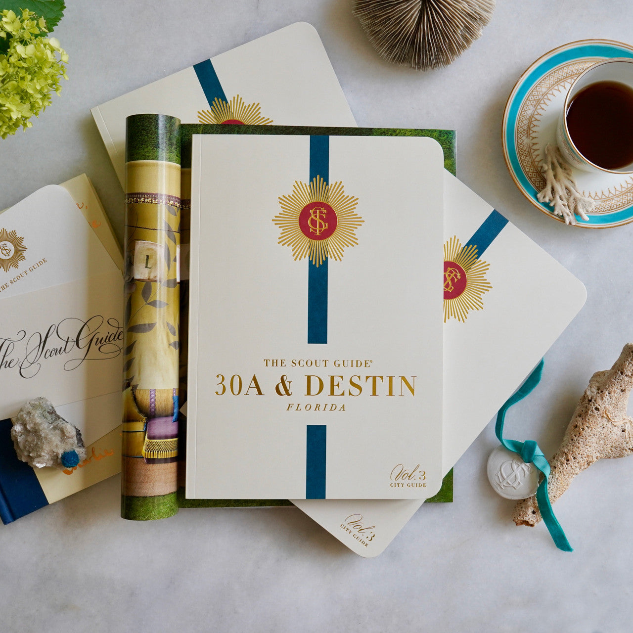 The Scout Guide 30A & Destin Volume 3, cream cover with aqua blue  stripe, gold foil title and TSG Medallion logo
