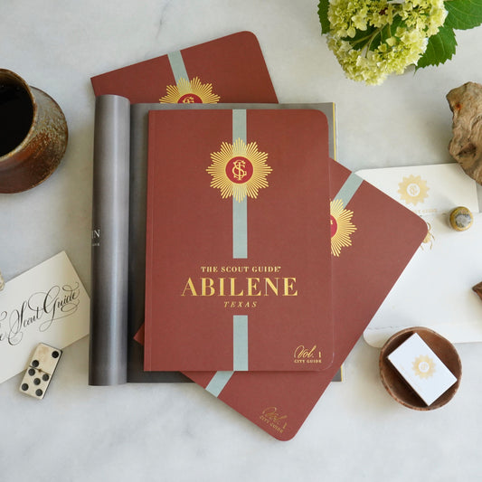 The Scout Guide Abilene, Volume 1, burnt orange cover with light blue stripe, gold foil title and TSG Medallion