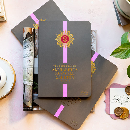 The Scout Guide Alpharetta, Roswell, & Milton Volume 2, grey brown cover with pink stripe, gold foil title and TSG Medallion logo