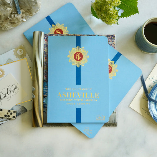 The Scout Guide Asheville Volume 8, light blue cover with dark blue stripe, gold foil title and TSG Medallion logo
