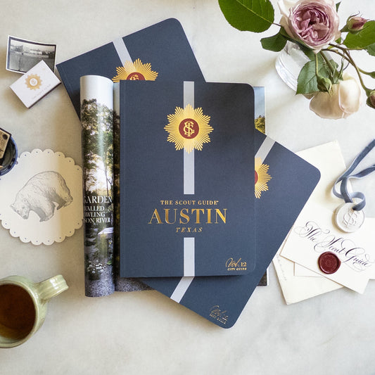 The Scout Guide Austin Volume 12, navy blue cover with light blue stripe, gold foil title and TSG Medallion logo