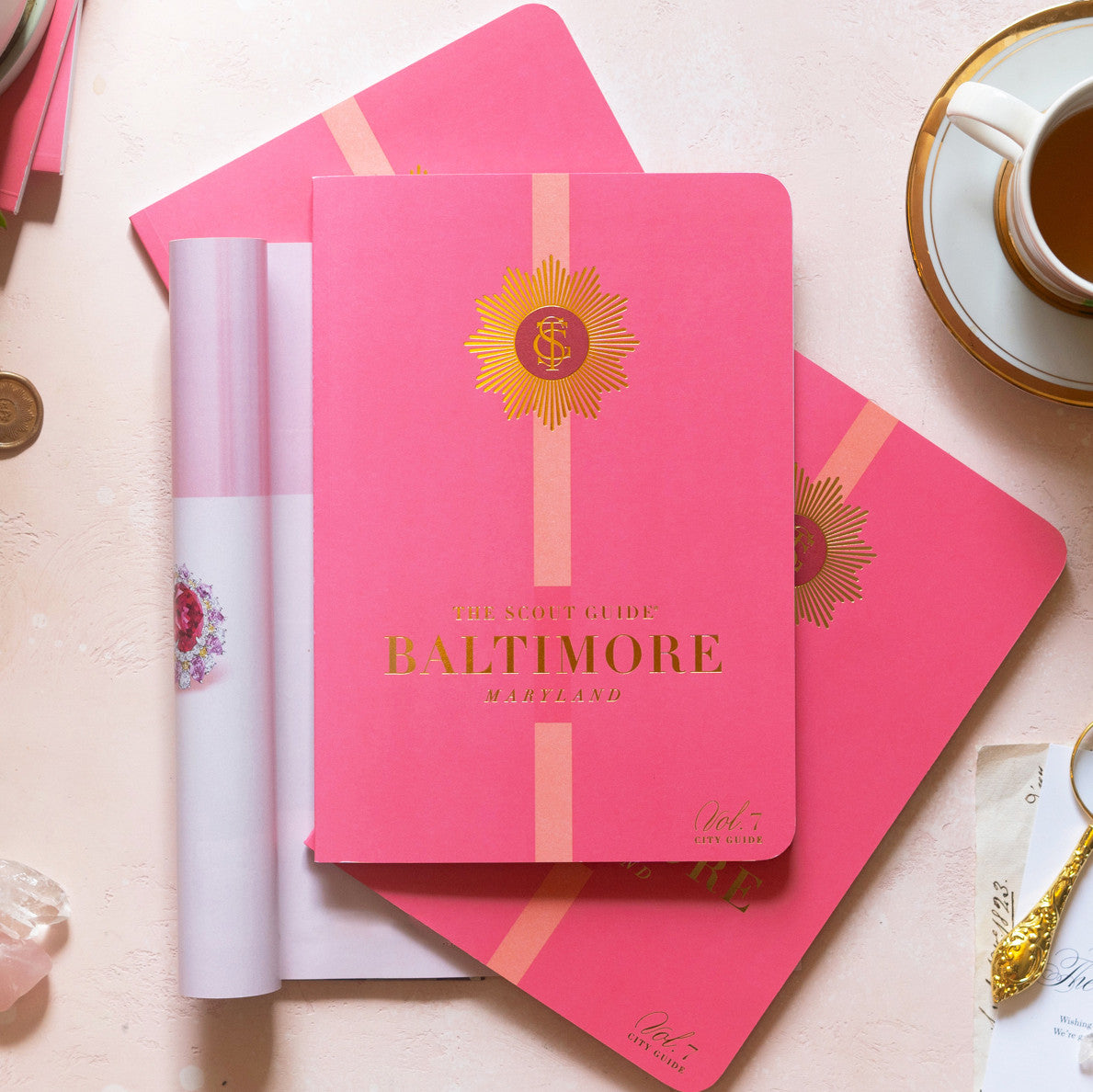 The Scout Guide Baltimore Volume 7, hot pink cover with light pink stripe, gold foil title and TSG Medallion logo