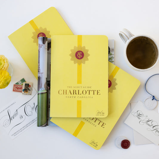 The Scout Guide Charlotte, Volume 14, bright yellow cover with light yellow stripe, gold foil title and TSG Medallion