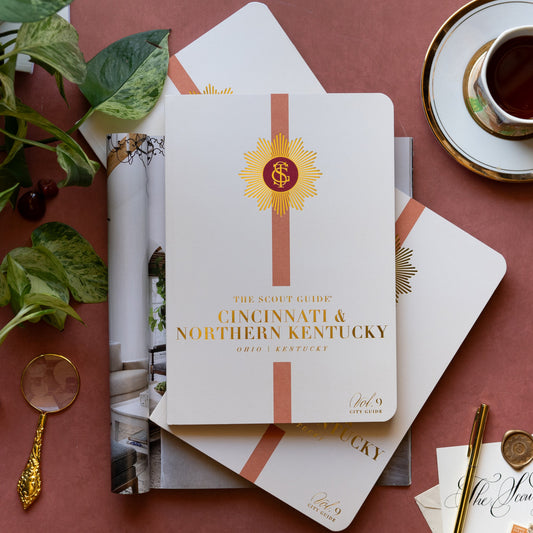 The Scout Guide Cincinnati & Northern Kentucky Volume 9, cream cover with dark orange stripe, gold foil title and TSG Medallion logo