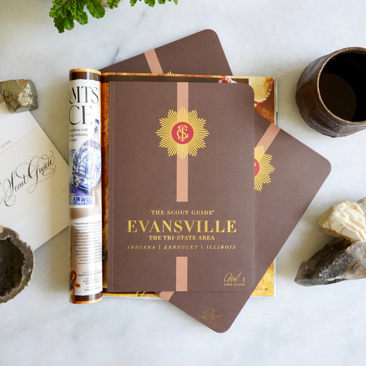 The Scout Guide Evansville & The Tri State Area Volume 1, brown cover with light brown stripe, gold foil title and TSG Medallion logo