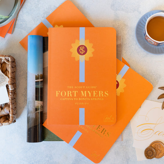 The Scout Guide Fort Myers Volume 1, orange cover with aqua stripe, gold foil title and TSG Medallion logo