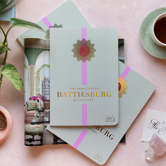 The Scout Guide Hattiesburg Volume 2, light mint green cover with pink stripe, gold foil, and TSG medallion