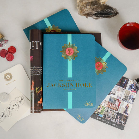The Scout Guide Jackson Hole Volume 12, turqouise cover with an aqua stripe, gold foil title and TSG Medallion logo