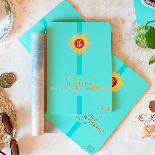The Scout Guide Jupiter & Palm Beach Gardens Volume 4, sea foam cover with turquoise stripe, gold foil title and TSG Medallion logo