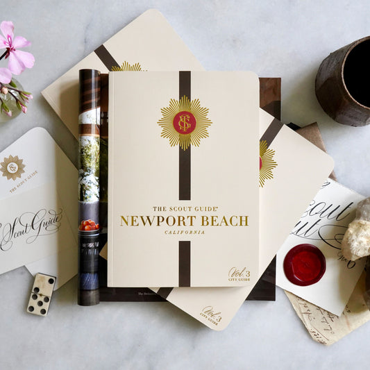 The Scout Guide Newport Beach Volume 3, beige cover with black stripe, gold foil title and TSG Medallion logo