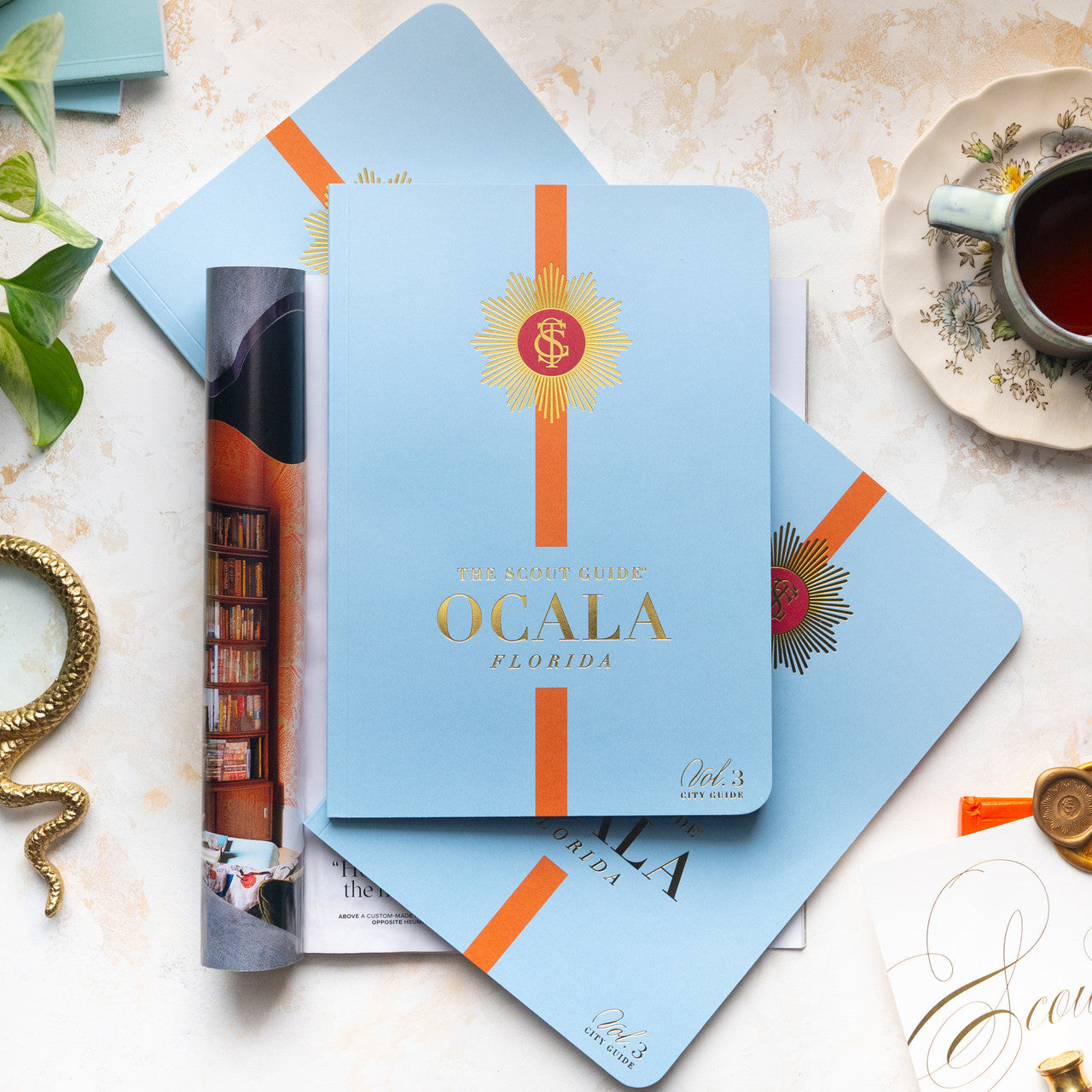The Scout Guide Ocala Volume 3, light blue cover with burnt orange stripe, gold foil title and TSG Medallion logo
