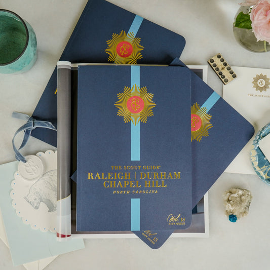 The Scout Guide Raleigh, Durham, & Chapel Hill Volume 13, dark blue cover with turquoise stripe, gold foil title and TSG Medallion logo