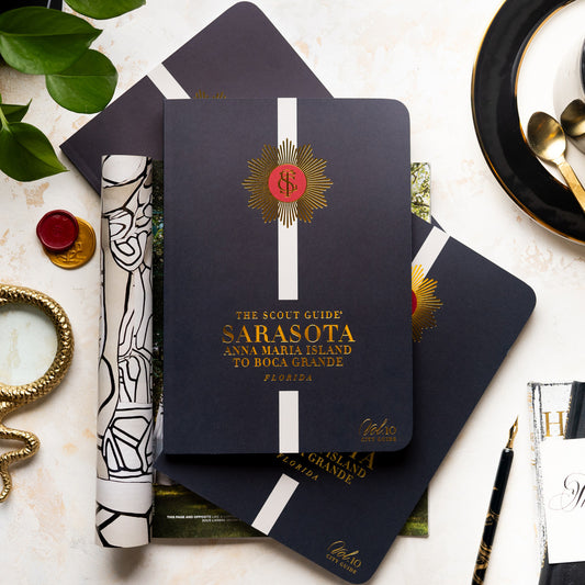 The Scout Guide Sarasota Volume 10, black cover with cream stripe, gold foil title and TSG Medallion logo