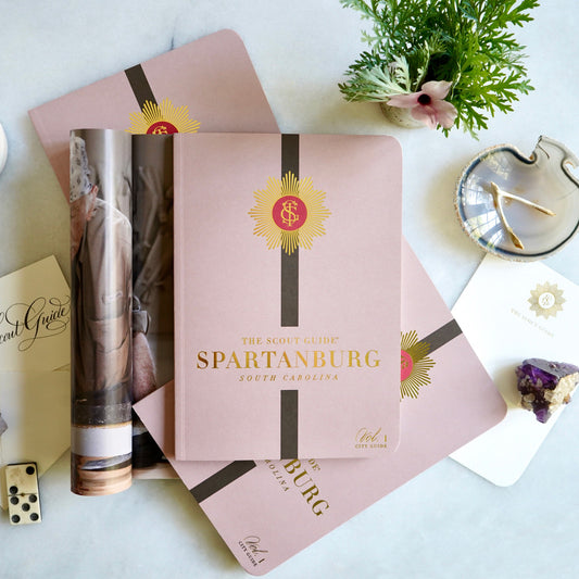 The Scout Guide Spartanburg Volume 1, light brown cover with dark brown stripe, gold foil title and TSG Medallion logo